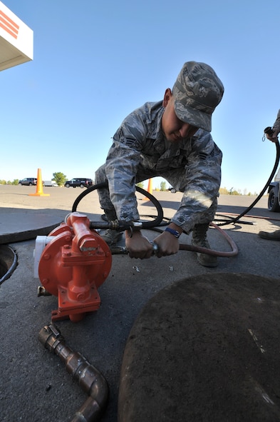 MINOT AIR FORCE BASE, N.D. -- Senior Airman Sixto Trevino, 5th Civil Engineer Squadron water and fuel systems maintainer, prepares his equipment to perform work on a fuel tank here, Sept. 12. Keeping the water level down is a recurring maintenance job that keeps the fuel system running correctly. (U.S. Air Force photo/Senior Airman Brittany Y. Auld)