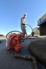 MINOT AIR FORCE BASE, N.D. -- Airman 1st Class Wilson Arocho, 5th Civil Engineer Squadron water and fuel systems maintainer, prepares his equipment to perform work on a fuel tank here, Sept. 12. Keeping the water level down is a recurring maintenance job that keeps the fuel system running correctly. (U.S. Air Force photo/Senior Airman Brittany Y. Auld)