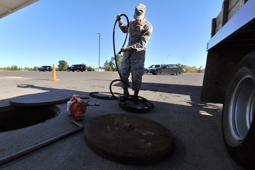 MINOT AIR FORCE BASE, N.D. -- Senior Airman Sixto Trevino, 5th Civil Engineer Squadron water and fuel systems maintainer, prepares his equipment to perform work on a fuel tank here, Sept. 12. Keeping the water level down is a recurring maintenance job that keeps the fuel system running correctly. (U.S. Air Force photo/Senior Airman Brittany Y. Auld)