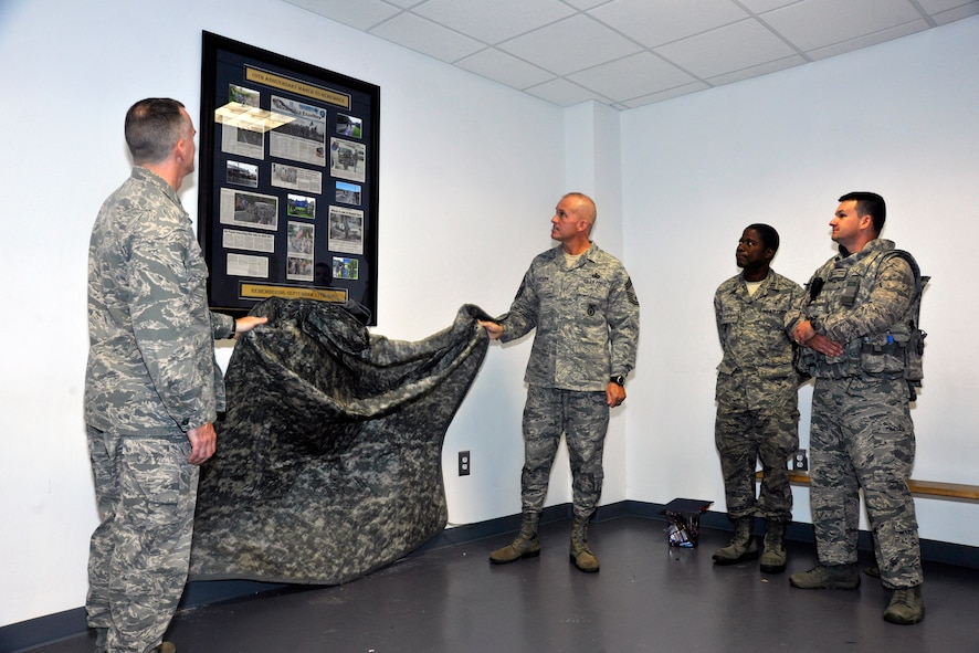 Col. Erik Goepner, 11th Security Forces Group commander, and Chief Master Sgt. Todd Fuller, 11th SFG command chief, reveal a 10th Anniversary of 9/11 plaque to fellow 11th SFG members Sept. 11, 2012. The plaque highlighted the group’s participation in a 9/11 Memorial Ruck March the year prior. After the plaque was revealed, the Airmen participated in this year’s march, which stretched nine miles and 11,000 meters around the perimeter of Joint Base Andrews. (U.S. Air Force photo/Senior Airman Lindsey A. Porter)