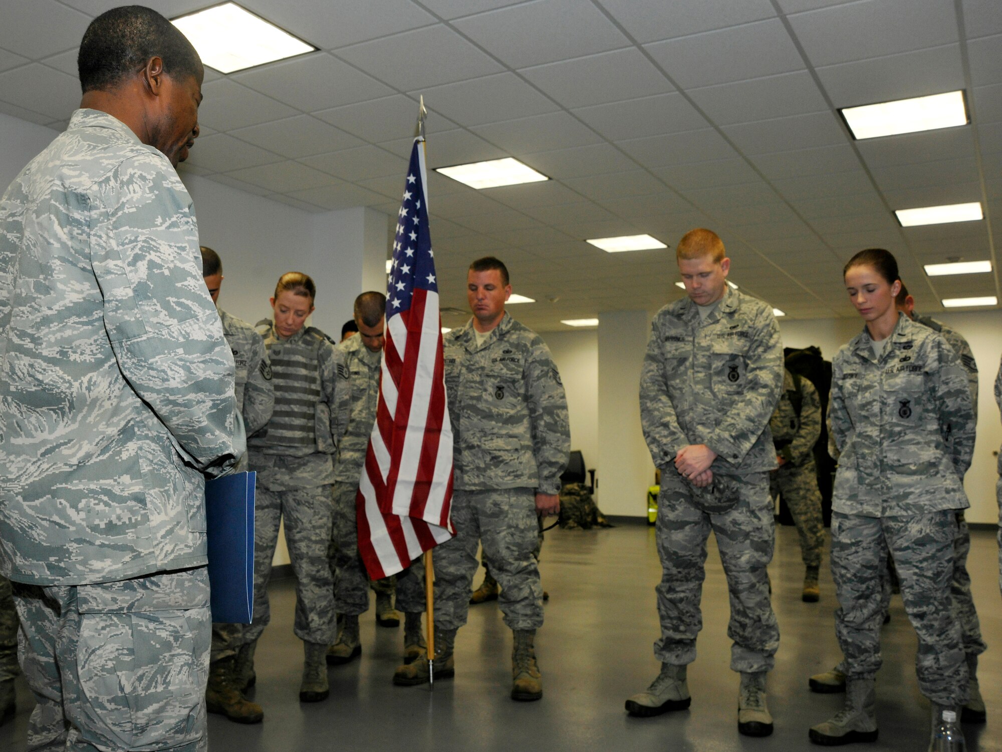 Chaplain (Capt.) Denis Gueu, 11th Wing chaplain, offers a prayer of protection and thanks to 11th Security Forces Group Airmen before they begin a nine-mile and 11,000-meter ruck march Sept. 11, 2012. The Airmen held the march on the eleventh anniversary of the 9/11 terrorist attacks. The march lasted more than three hours and traced the perimeter of the installation. (U.S. Air Force photo/Senior Airman Lindsey A. Porter)