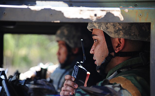 Tech. Sgt. Cory Hasegawa, 647th Security Forces, radios another vehicle about a suspicious individual during an Operational Readiness Exercise on Joint Base Pearl Harbor-Hickam, Hawaii, Sept. 12. The exercise scenario involved a vehicle ambush and a personnel recovery mission. (U.S. Air Force photo/Senior Airman Lauren Main)