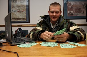 U.S. Air Force Senior Airman Aaron Wanzer, 366th Comptroller Squadron retirement and separations team lead, uses simulated funds to provide realistic training during an Operational Readiness Exercise held Sep. 13, 2012, at Mountain Home Air Force Base, Idaho. The ORE is being held in preparation for the Operational Readiness Inspection slated for April 2013. (U.S. Air Force Photo/Staff Sgt. Roy Lynch)