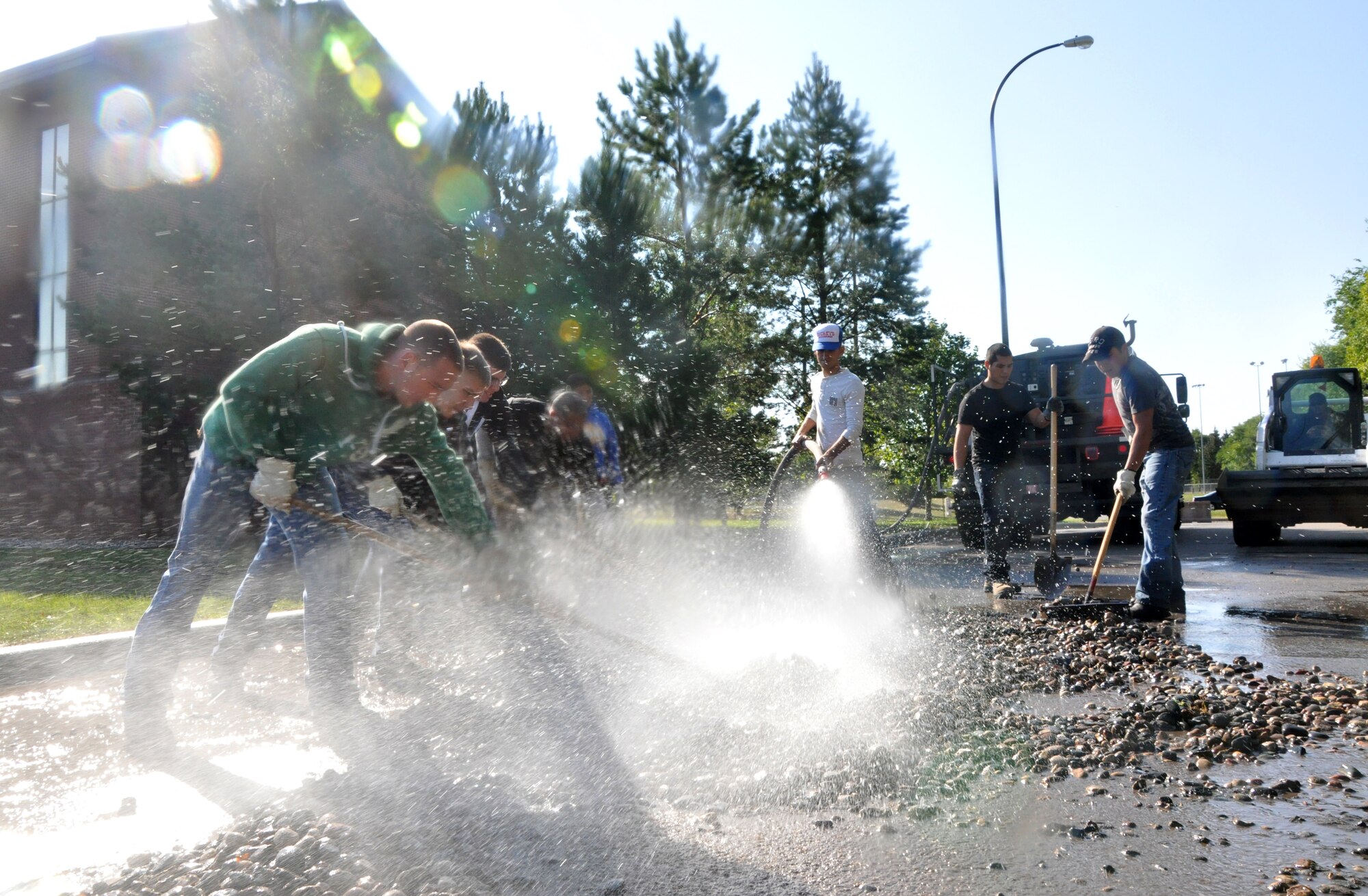 Volunteer Airmen shovel and clean display rocks from around Barnes Hall on Sept. 10, 2012, on Grand Forks Air Force Base, N.D.  More than 40 Airmen here volunteered their time to help in the re-landscaping of Barnes Hall, the base’s largest dormitory living quarters. (U.S. Air Force photo by Airman 1st Class Xavier Navarro)