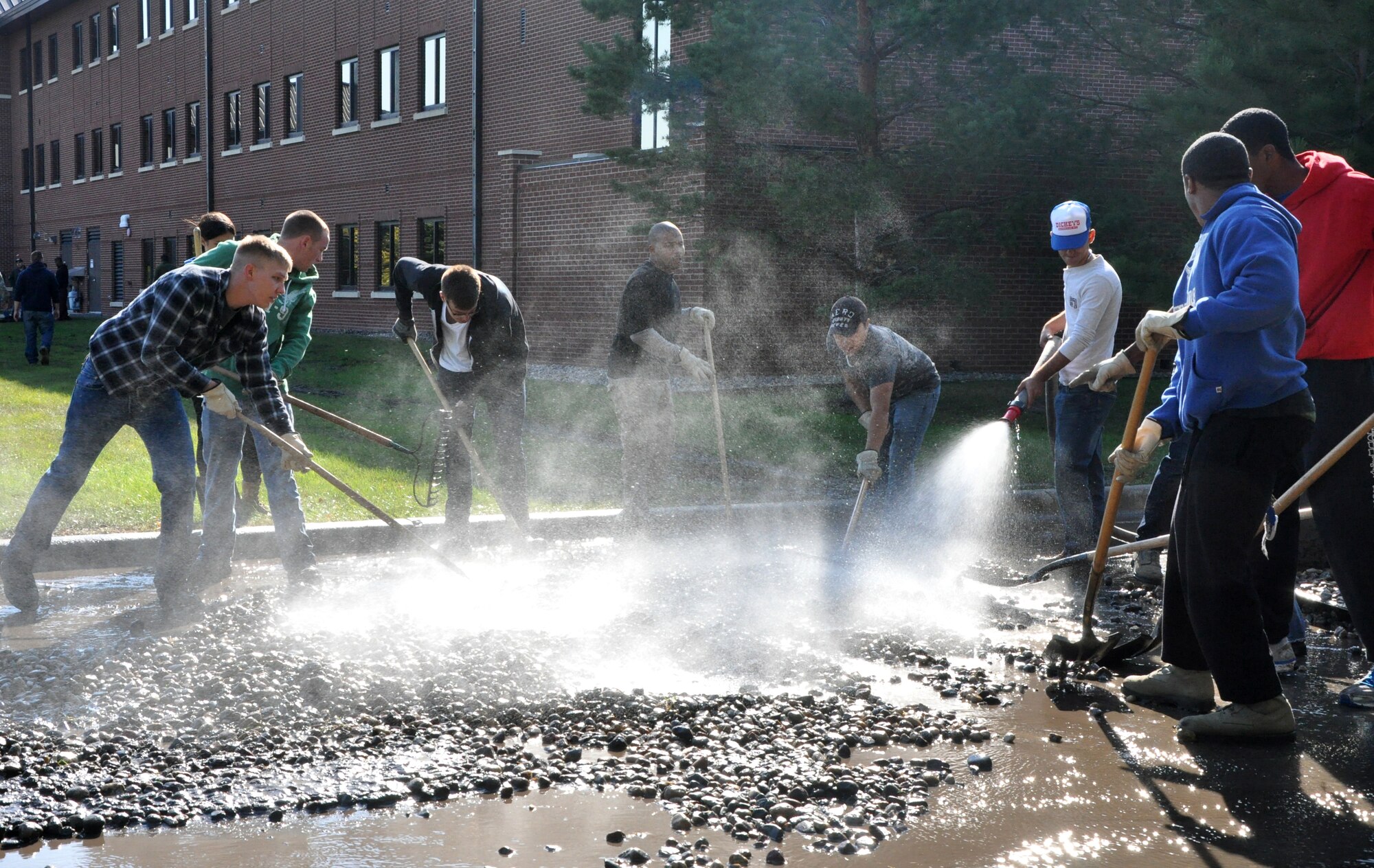 Volunteer Airmen clean display rocks from around Barnes Hall on Sept. 10, 2012, on Grand Forks Air Force Base, N.D.  More than 40 Airmen here volunteered their time to help in the re-landscaping of Barnes Hall, the base’s largest dormitory living quarters. (U.S. Air Force photo by Airman 1st Class Xavier Navarro)