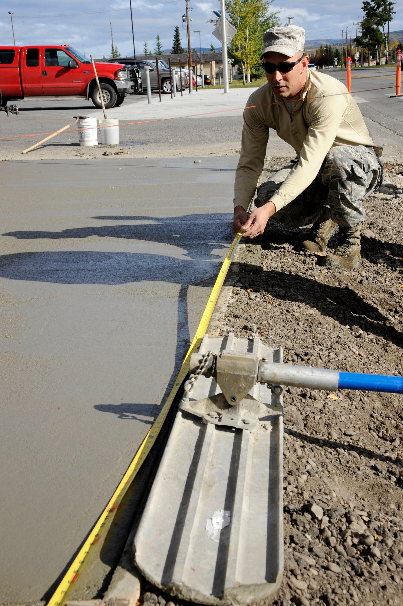 U.S. Air Force Staff Sgt. William Walker, 354th Civil Engineer Squadron pavement equipment operator, measures the length of a concrete slab Sept. 10, 2012, Eielson Air Force Base, Alaska. The concrete is measured to ensure future joints are created evenly. (U.S. Air Force photo/ Staff Sgt. Jim Araos)