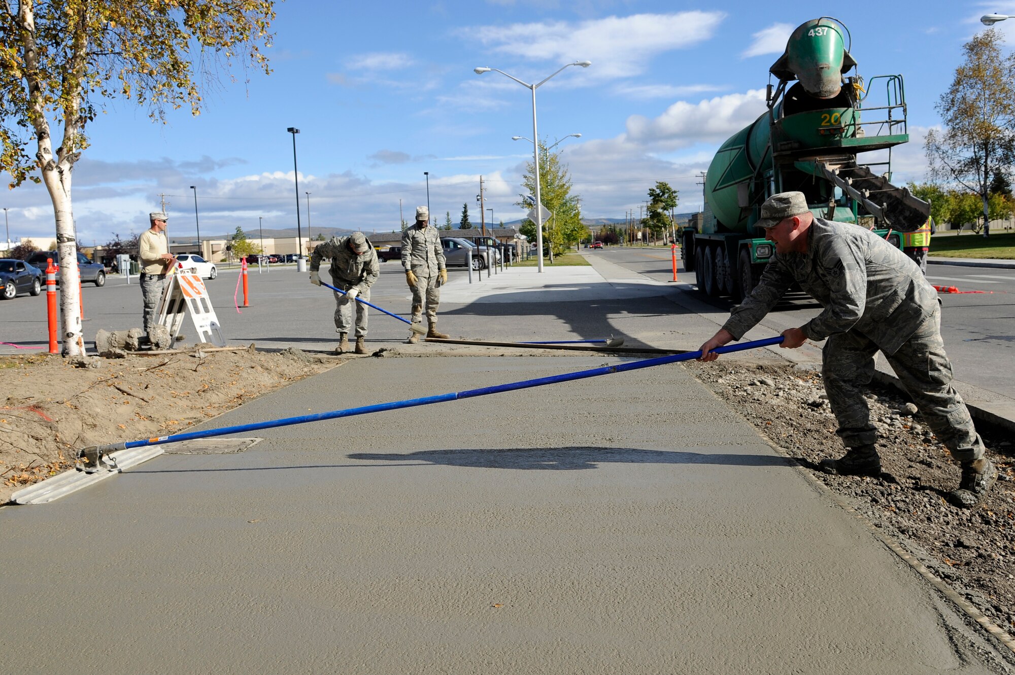 U.S. Air Force Senior Airman Justin Trammell, 354th Civil Engineer Squadron pavement equipment operator, sweeps concrete with a bull float Sept. 10, 2012, Eielson Air Force Base, Alaska.  A bull float is a tool used to remove surface imperfections on wet concrete for future work. (U.S. Air Force photo/Staff Sgt. Jim Araos)