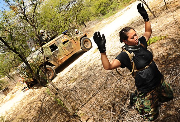 Airman 1st Class Lucia Leija calls out detainment instructions to Staff Sgt. Kristen Cruz, both 647th Security Forces, during  an Operational Readiness Exercise on Joint Base Pearl Harbor-Hickam, Hawaii, Sept. 12. The exercise scenario involved a vehicle ambush and a personnel recovery mission. (U.S. Air Force photo/Senior Airman Lauren Main)