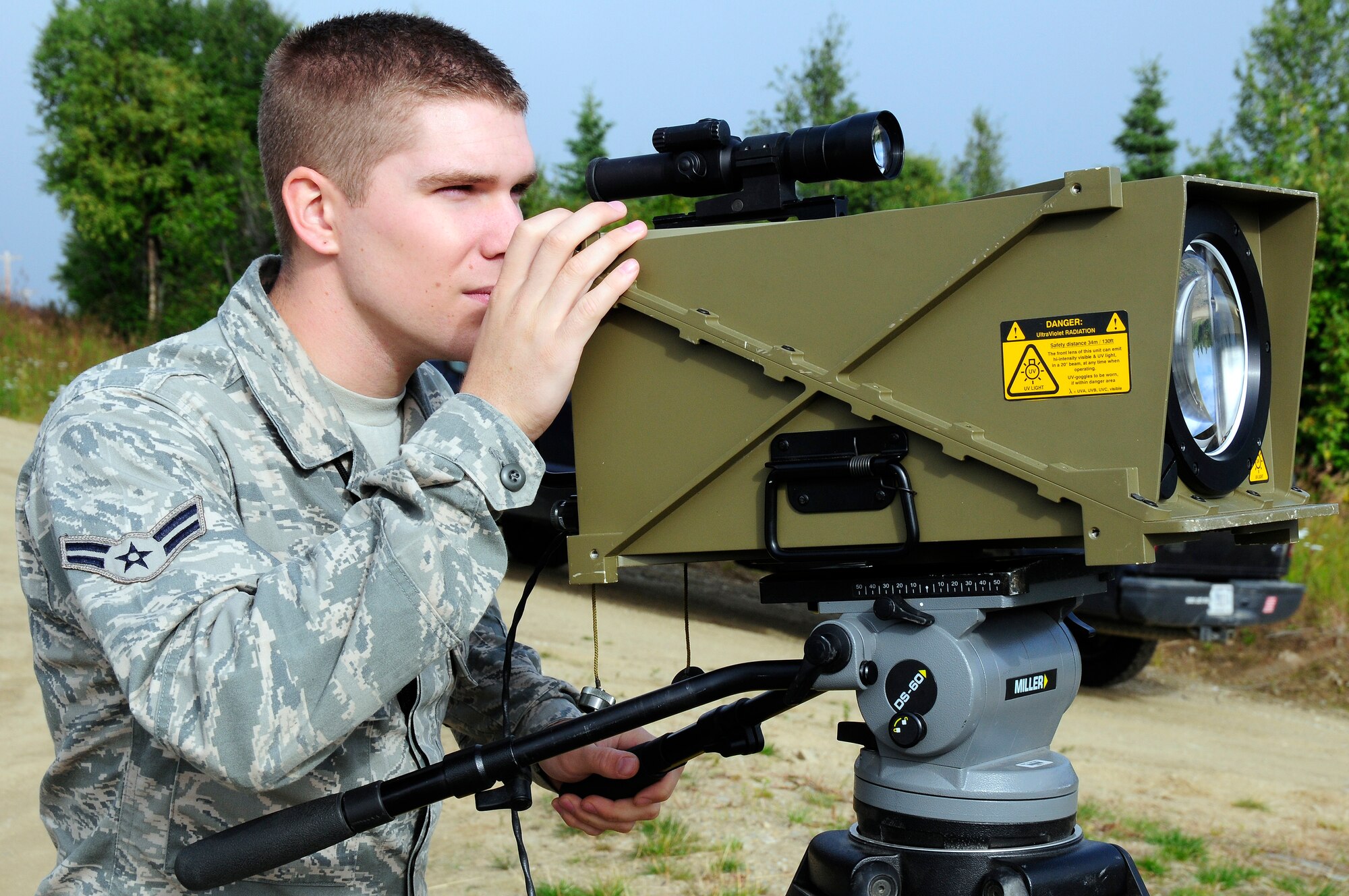 U.S. Air Force Airman 1st Class Brandon Larsen, 353rd Combat Training Squadron range division quality assurance evaluator, looks through the scope of a UV Mallina simulator/stimulator Aug. 17, 2012, Eielson Air Force Base, Alaska. The Mallina is used during exercises to emulate the UV signature of surface-to-air missile rocket motors. (U.S. Air Force photo/Airman 1st Class Zachary Perras)