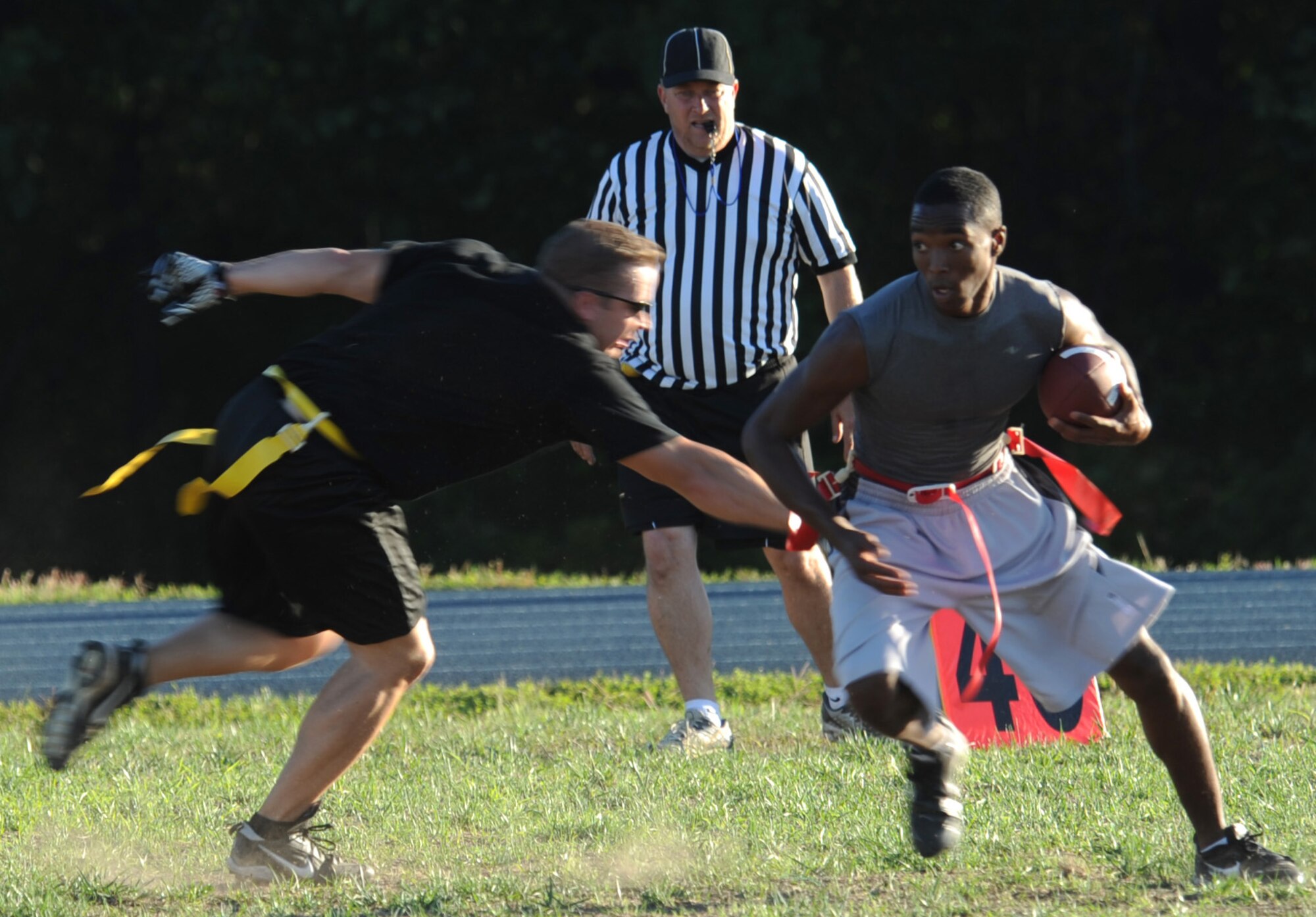 WHITEMAN AIR FORCE BASE, Mo. – Joseph Flowers, 509th Medical Group wide receiver, dodges a defender after making a catch against the 509th Force Support Squadron Sept. 10. After a 0-0 first half, MDG scored two touchdowns to shutout FSS 12-0. (U.S. Air Force photo/Airman 1st Class Bryan Crane)(Released)
