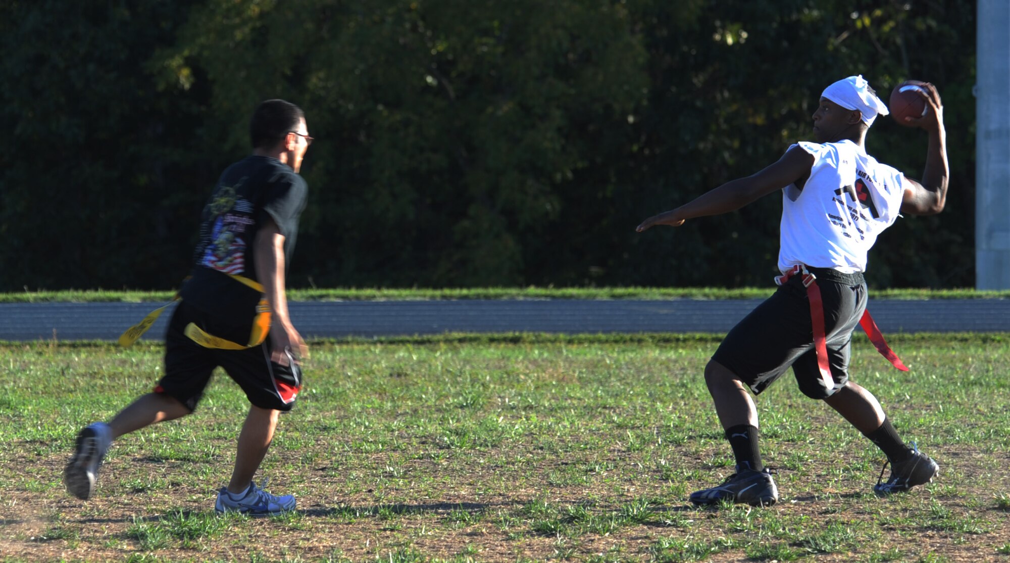WHITEMAN AIR FORCE BASE, Mo. – Jerome Whitfield, 509th Medical Group quarterback, drops back for a pass against the 509th Force Support Squadron Sept. 10. The 509th MDG scored two late touchdowns in the second half to defeat the 509th FSS 12-0. (U.S. Air Force photo/Airman 1st Class Bryan Crane)(Released)