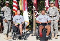 Maj. Gen. M. Ted Wong, commander of Brooke Army Medical Center, (far right) and BAMC Command Sgt. Maj. Marshall L. Huffman (far left) host a Purple Heart ceremony in honor of Sgt. Michael J. Lassey (left) and Sgt. Jamel M. Abdulaziz, who were wounded this summer in Afghanistan. (Photo by Elaine Sanchez, BAMC Public Affairs)