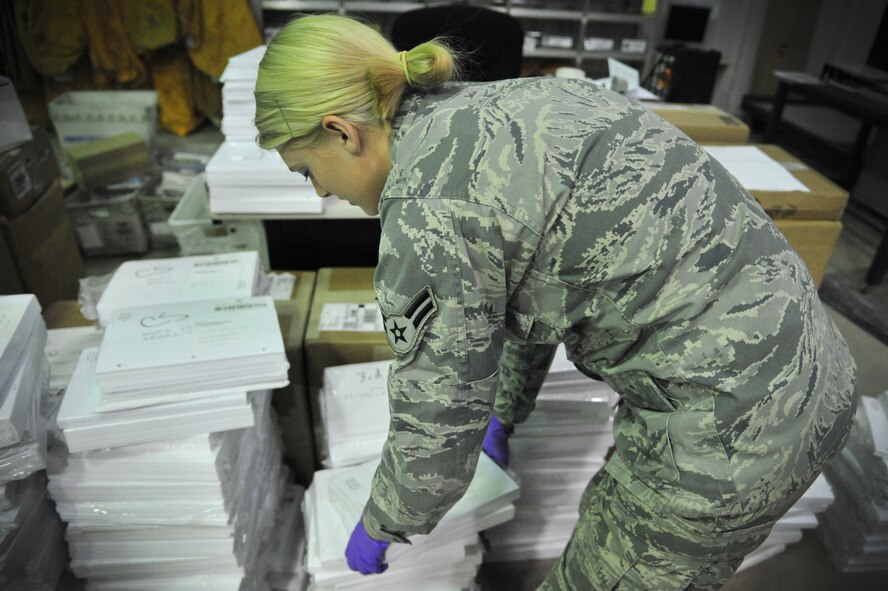 U.S. Air Force Airman 1st Class Daisey Forsyth, 27th Special Operations Communications Squadron knowledge operations manager, sorts through items to be distributed to squadrons at Cannon Air Force Base, N.M., Sept. 11, 2012. Knowledge operations managers ensure communication channels flow seamlessly across the 27th Special Operations Wing. (U.S. Air Force photo/Airman 1st Class Alexxis Pons Abascal)  