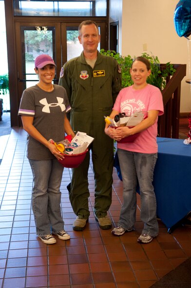 U.S. Air Force Staff Sgts. Vanessa Thomas and Rebecca Gaddy, Team Tasty  Tiger Baking Company members, pose with Col. Billy Thompson, 23d Wing commander, during the Cupcake Wars Competition at Moody Air Force Base, Ga., Aug. 28, 2012. The Tasty Tiger Baking  Company team is the reigning champion of the annual competition, and they have won the past two competitions. (U.S. Air Force photo by Airman 1st Class Paul Francis/Released)
