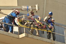 MINOT AIR FORCE BASE, N.D. -- Senior Airman Reginald Bramlett, firefighter for Barksdale Air Force Base, La.’s, 2nd Civil Engineering Squadron, Tech Sgt. David Hagenbuch, 312th Training Squadron instructor and Senior Airman Andrew Fruehan, of the 5th Civil Engineering Squadron, lower a mock victim down to safety during high angle rescue training exercise here, Aug. 20. Rescue Technician Instructors Staff Sgt. Aaron Brackett and Tech Sgt. David Hagenbuch from the Louis F. Garland Department of Defense Fire Academy at Goodfellow Air Force Base, Texas, came to Minot AFB as part of the Mobile Training Team. The MTT goes from base to base offering training that is conducted year round at the Fire Academy. (U.S. Air Force photo/Senior Airman Brittany Y. Auld)