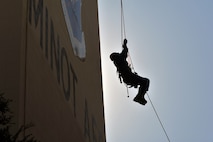 MINOT AIR FORCE BASE, N.D. -- Senior Airman Reginald Bramlett, a firefighter from Barksdale Air Force Base, La.’s, 2nd Civil Engineering Squadron, ascends up a rope during high angle rescue training exercise here, Aug. 20. Airmen were taught low and high angle rescue procedures as well as rappelling-- which included passing a knot in the line, rappelling down to an individual, ascending up a rope, patient pick off rescues, and confined space rescues. (U.S. Air Force photo/Senior Airman Brittany Y. Auld)