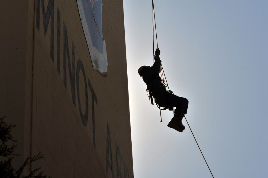 MINOT AIR FORCE BASE, N.D. -- Senior Airman Reginald Bramlett, a firefighter from Barksdale Air Force Base, La.’s, 2nd Civil Engineering Squadron, ascends up a rope during high angle rescue training exercise here, Aug. 20. Airmen were taught low and high angle rescue procedures as well as rappelling-- which included passing a knot in the line, rappelling down to an individual, ascending up a rope, patient pick off rescues, and confined space rescues. (U.S. Air Force photo/Senior Airman Brittany Y. Auld)