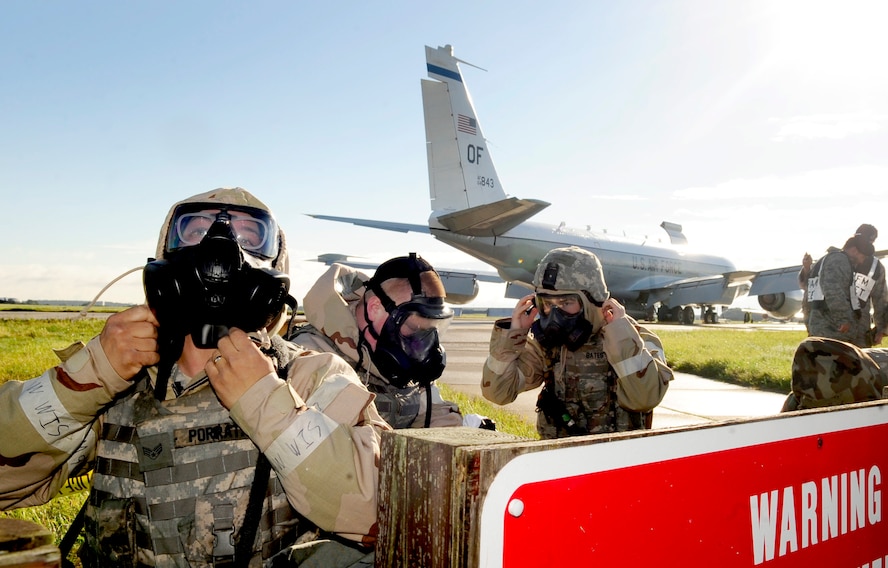 RAF MILDENHALL, England – Airmen from the 100th Security Forces Squadron, don chemical warfare gear after a simulated chemical attack during an operational readiness exercise Sept. 11, 2012, at RAF Mildenhall. The simulated attack was held to test Airmen’s ability to don their gear in a timely and effective manner to ensure safety. (U.S. Air Force photo/Senior Airman Ethan Morgan)