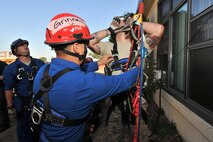 MINOT AIR FORCE BASE, N.D. – Senior Airman Derrick Grinell, 5th Civil Engineering Squadron firefighter, checks Senior Airman Andrew Fruehan’s, 5th CES firefighter, gear during a high angle rescue training exercise, Aug. 20. Airmen were taught low and high angle rescue procedures as well as rappelling-- which included passing a knot in the line, rappelling down to an individual, ascending up a rope, patient pick off rescues, and confined space rescues. (U.S. Air Force photo/Senior Airman Brittany Y. Auld)