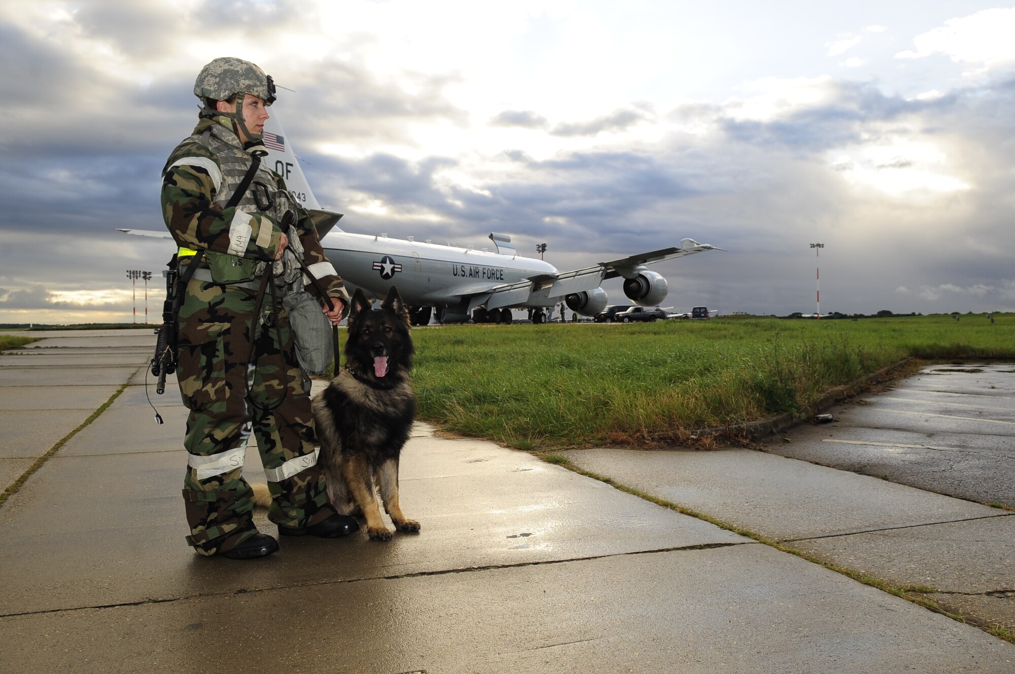 RAF MILDENHALL, England – Staff Sgt. Kelly Szydlo, 100th Security Forces Squadron military working dog handler, and MWD Ajax wait until they are needed during an operational readiness exercise Sept. 11, 2012, at RAF Mildenhall. The ORE consisted of two phases with phase one consisting of personnel's readiness to leave and travel to the deployed location while phase two involved wartime operations and training. (U.S. Air Force photo/Senior Airman Ethan Morgan)