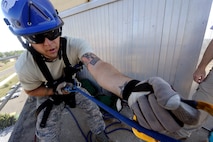 MINOT AIR FORCE BASE, N.D. – Senior Airman Andrew Fruehan, 5th Civil Engineering Squadron firefighter, secures a his rope at the top of the air traffic control tower during a high angle rescue training exercise here, Aug. 20. Instructors from the Louis F. Garland Department of Defense Fire Academy at Goodfellow Air Force Base, Texas, came to Minot AFB as part of the Mobile Training Team taught Minot Airmen low and high angle rescue procedures as well as rappelling including passing a knot in the line, patient pick off rescues, and confined space rescues base helping to keep Minot fire fighters sharp in their capabilities to save lives in the face of danger.  (U.S. Air Force photo/Senior Airman Jesse Lopez)