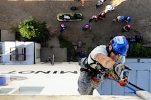 MINOT AIR FORCE BASE, N.D. – Senior Airman Andrew Fruehan, 5th Civil Engineering Squadron firefighter, ascends to the top of the air traffic control tower during a high angle rescue training exercise here, Aug. 20. Instructors from the Louis F. Garland Department of Defense Fire Academy at Goodfellow Air Force Base, Texas, came to Minot AFB as part of the Mobile Training Team taught Minot Airmen low and high angle rescue procedures as well as rappelling including passing a knot in the line, patient pick off rescues, and confined space rescues base helping to keep Minot fire fighters sharp in their capabilities to save lives in the face of danger.  (U.S. Air Force photo/Senior Airman Jesse Lopez)