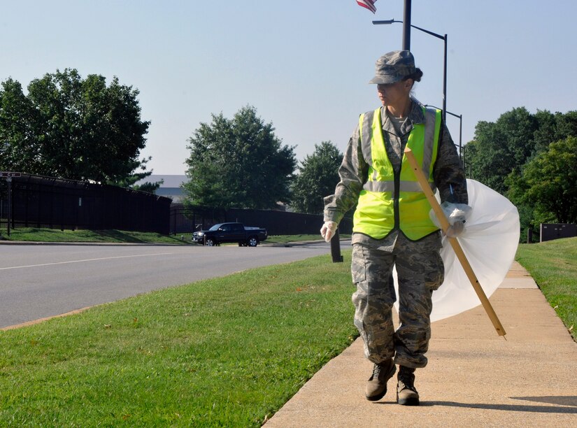 Senior Airman Tammy Workman, 744th Communications Group base records assistant, monitors Arkansas Ave. Aug. 16, 2012, for scattered litter. As a part of Andrews’ Base Pride detail, Workman works the week-long detail with approximately 5 other Airmen maintaining installation cleanliness and upholding Andrews’ sanitation standards. (U.S. Air Force photo/Senior Airman Lindsey A. Porter) 