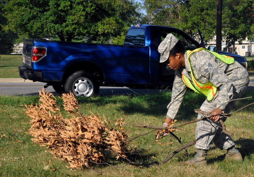 Senior Airman Cornelie Hall, 779th Medical Support Squadron command support staff and Base Pride detail Airman, collects tree debris Aug. 16, 2012. Base Pride is a week-long detail that works to maintain installation cleanliness and uphold Andrews’ sanitation standards. (U.S. Air Force photo/Senior Airman Lindsey A. Porter)