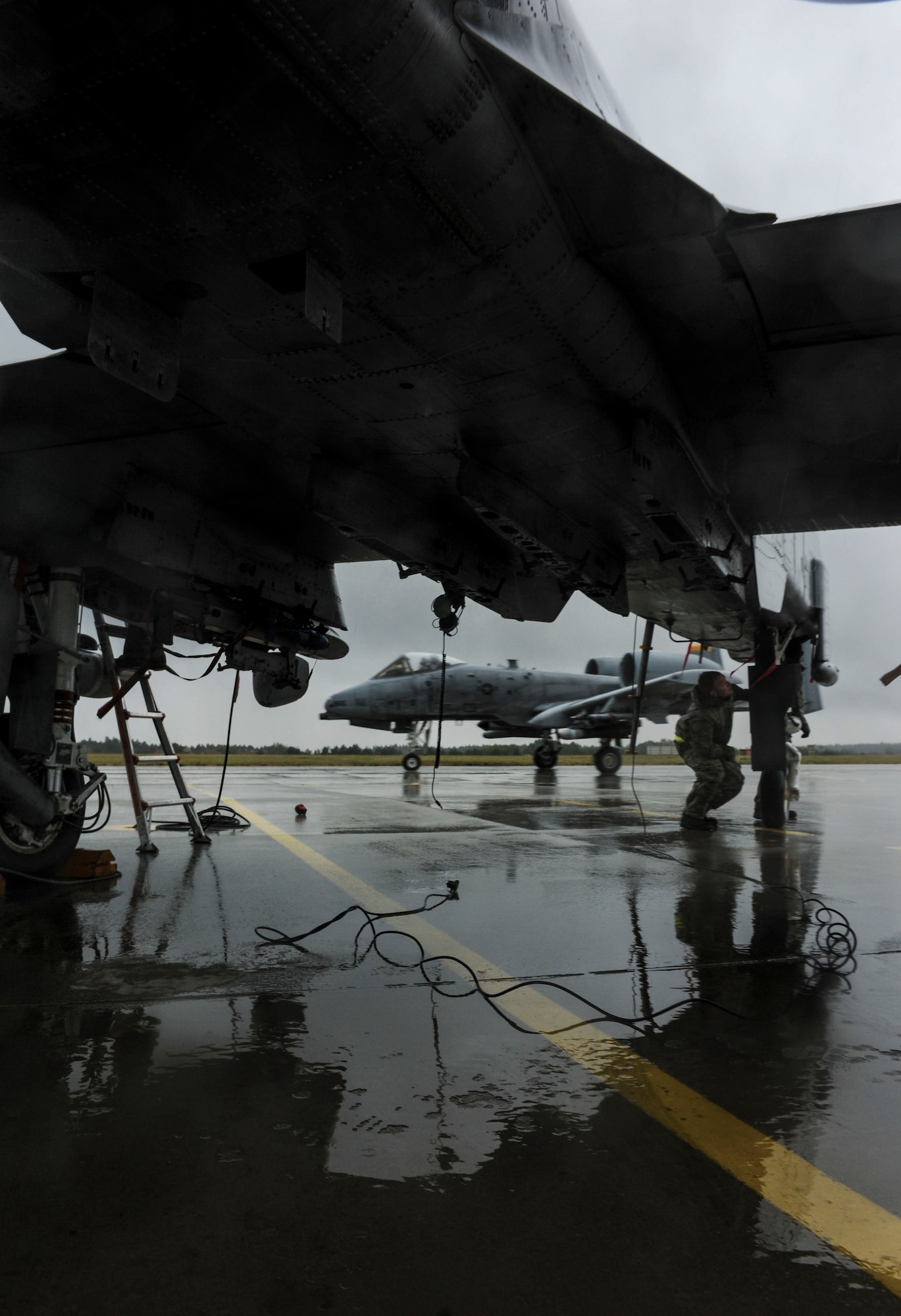 NAMEST AIR BASE, Czech Republic -- An 81st Fighter Squadron A-10 Thunderbolt II taxis down the runway here as a crew chief inspects another A-10 Sept. 12, during Ramstein Rover 2012. A-10 Thunderbolt IIs from the 81st FS are participating in the NATO exercise to provide close air support to partnering nations and practice forward air control missions with allies in international security assistance force realistic scenarios. Participating in exercises like RARO 12 ensures effective employment of airpower in support of alliance or coalition forces while mitigating risks to civilians in contingency operations. (U.S. Air Force photo by Senior Airman Natasha Stannard/ Released)