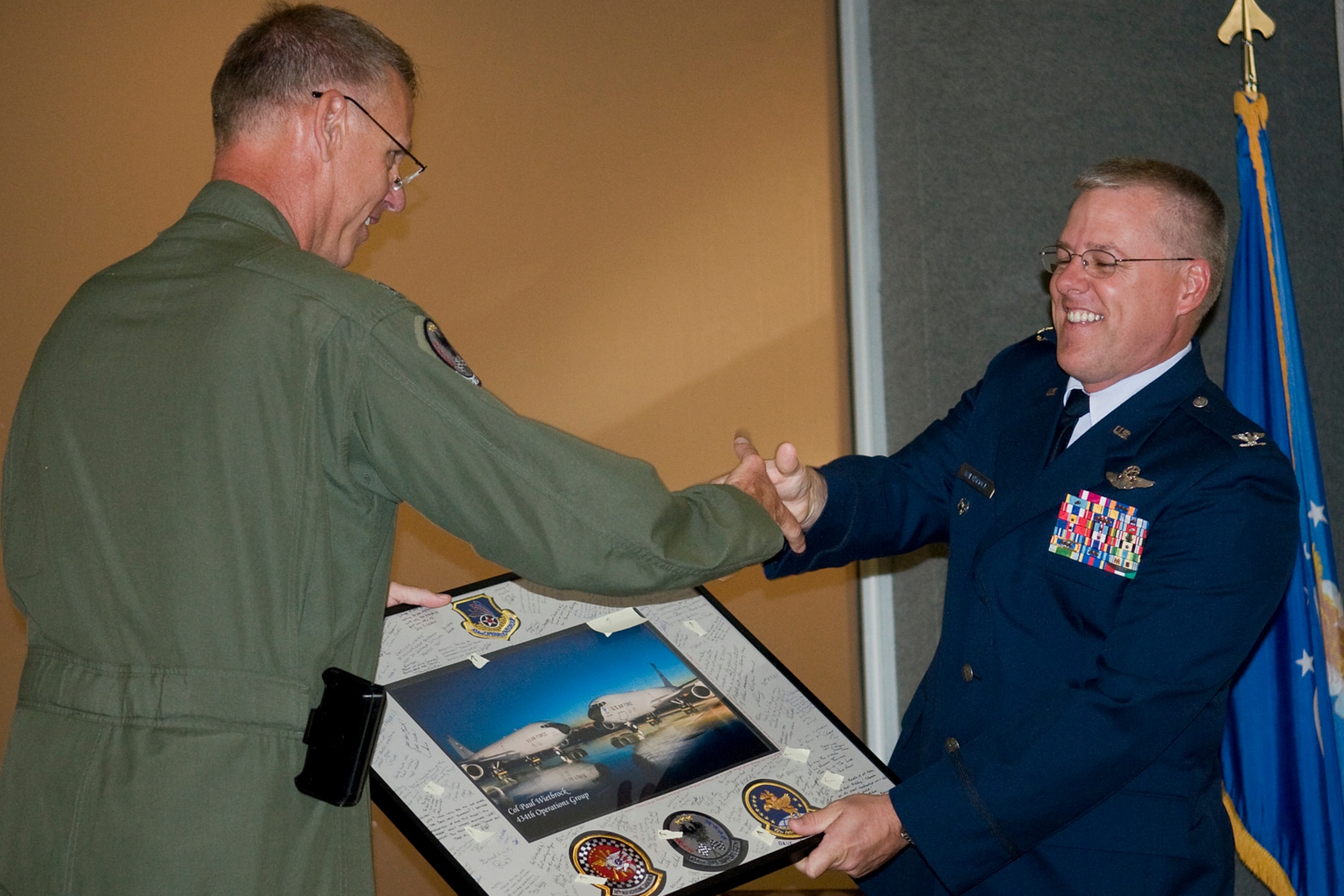 GRISSOM AIR RESERVE BASE, Ind. -- Lt. Col. Larry Shaw, 434th Operations Support Squadron commander, presents a newly promoted Col. Paul Wietbrock with a lithograph in appreciation for his many years of service at Grissom during Wietbrock's pin-on ceremony here Aug. 25.  Wietbrock left his position as 434th Operations Group deputy commander at Grissom a few months ago to take a post as the 931st Air Refueling Group deputy commander at McConnell Air Force Base, Kan. (U.S. Air Force photo/Tech. Sgt. Mark Orders-Woempner)

