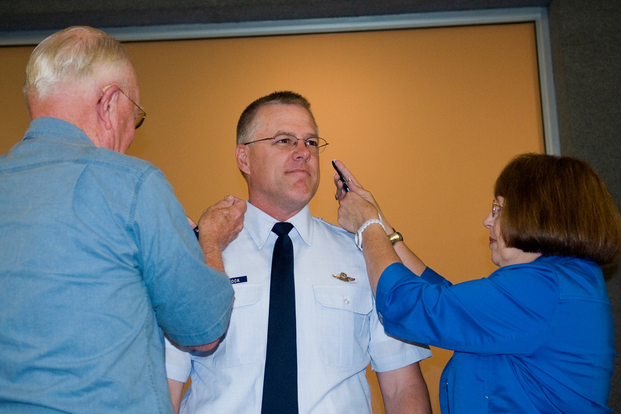 GRISSOM AIR RESERVE BASE, Ind. -- Ron and Judy Wietbrock pins colonel's eagles on their son, Paul Wietbrock, during his pin-on ceremony here Aug. 25. Shortly thereafter, Mr. Wietbrock, an Army veteran, saluted his son. (U.S. Air Force photo/Tech. Sgt. Mark Orders-Woempner)
