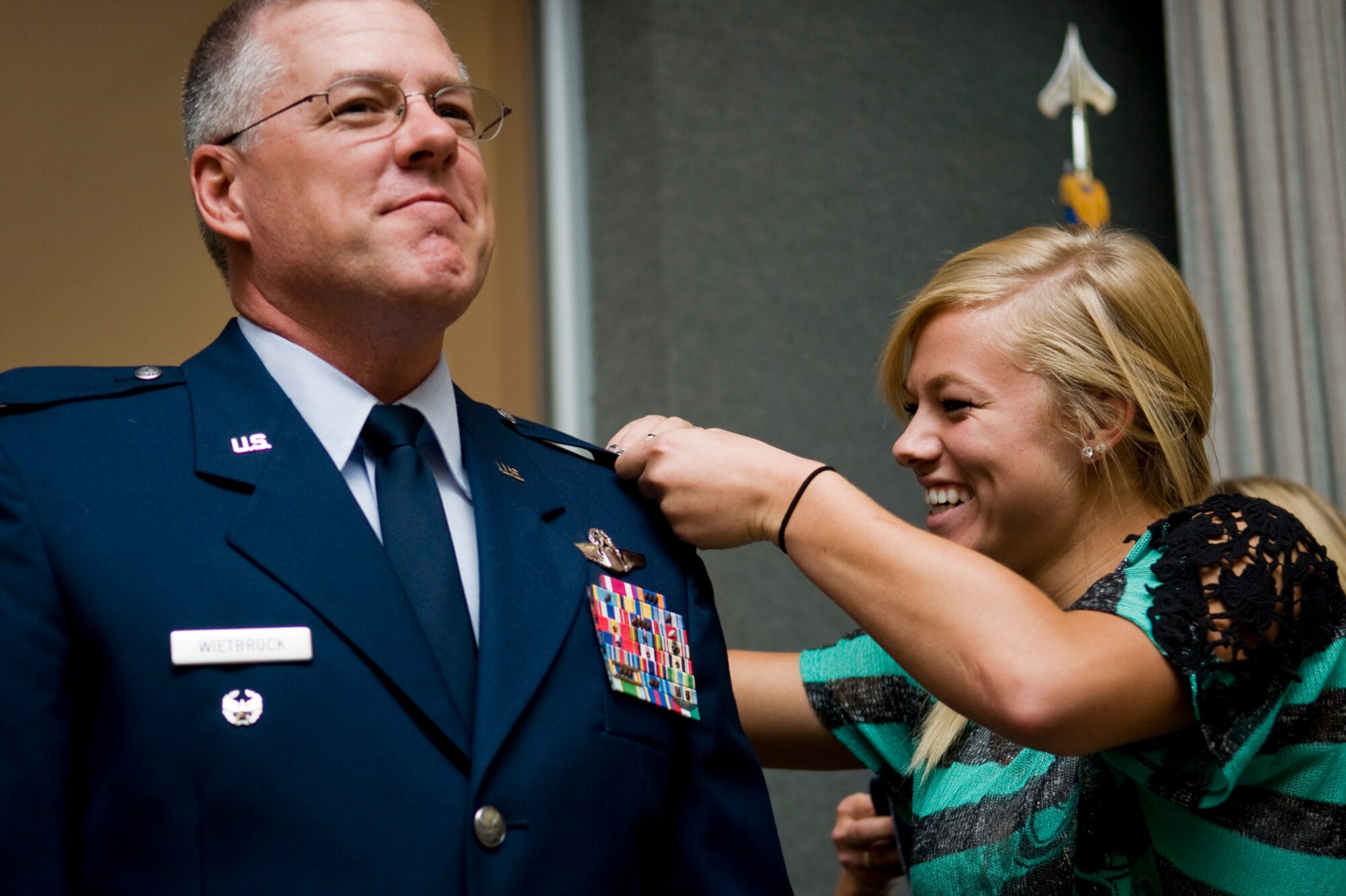 GRISSOM AIR RESERVE BASE, Ind. -- Sarah Wietbrock pin colonel's eagles on her dad, Paul Wietbrock, during a pin-on ceremony held here in Gus Grissom Hall Aug. 25. Wietbrock left his position as 434th Operations Group deputy commander at Grissom a few months ago to take a post as the 931st Air Refueling Group deputy commander at McConnell Air Force Base, Kan. (U.S. Air Force photo/Tech. Sgt. Mark Orders-Woempner)
