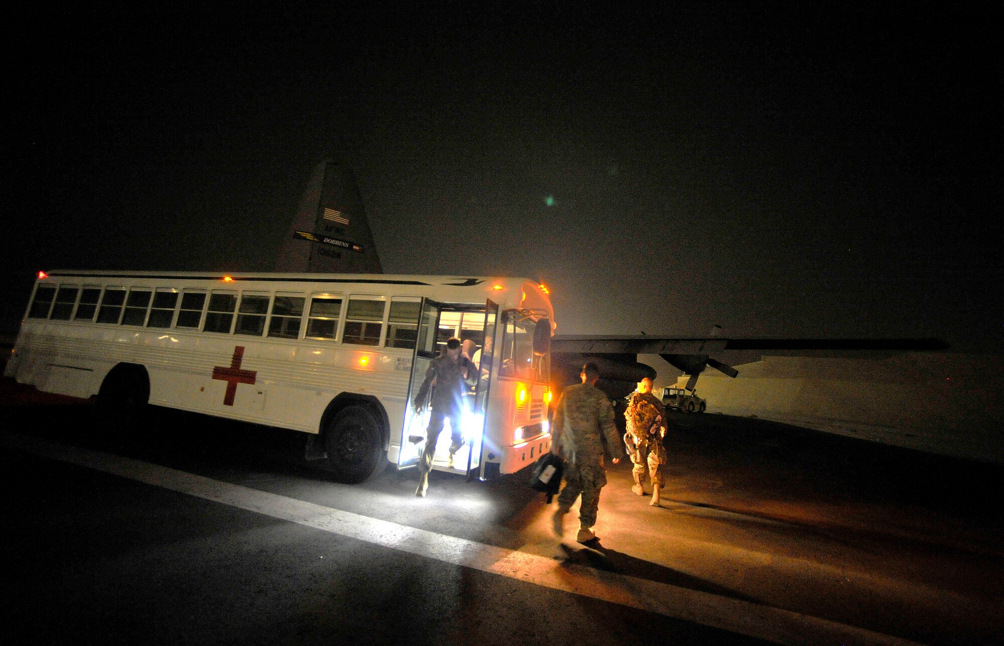U.S. Army members with the Inter Theater Care Program (ITCP) make their way out to a U.S. Air Force C-130 Hercules, which will transport them back to their deployed organizations, undisclosed location, Southwest Asia, August 30, 2012. These members are part of ITCP because they suffered from combat related injuries in the AOR. The ITCP was established in order to care for injured troops, who were able to be rehabilitated and returned to their respective units within the AOR. (U.S. Air Force photo/Staff Sgt. Clay Lancaster/ Released)
