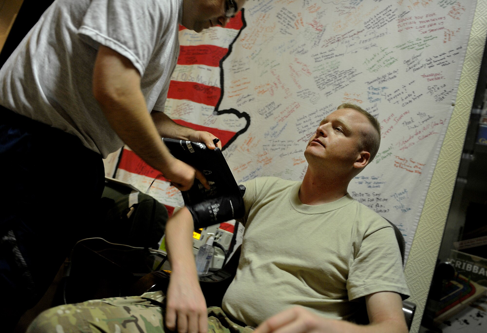 U.S. Air Force Staff Sgt. Jonathan Miranda, NCOIC Inter Theater Care Program (ITCP), checks the vitals of U.S. Army Spc. Chris Shuck, undisclosed location, Southwest Asia, August 30, 2012. Spc. Shuck is a member of the Inter Theater Care Program (ITCP) and spent several weeks healing from hernia surgery. The ITCP was established in order to care for injured troops, who were able to be rehabilitated and returned to their respective units within the AOR.   (U.S. Air Force photo/Staff Sgt. Clay Lancaster/ Released)
