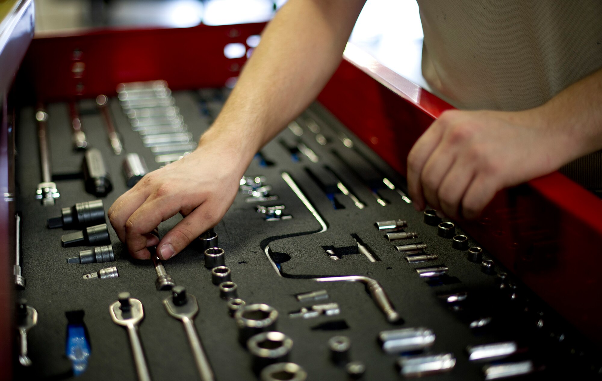 YOKOTA AIR BASE, Japan -- Staff Sgt. Synard Bert, 374th Maintanance Squadron propulsion flight aerospace propulsion journeyman, selects tools to use for scheduled maintenance on a C-130 engine at Yokota Air Base, Japan on Sept. 11, 2012. This proceess, which usually takes a week, involves several rounds of inspections and fixing possible broken parts. (U.S. Photo by Staff Sgt. Stacy Moless)