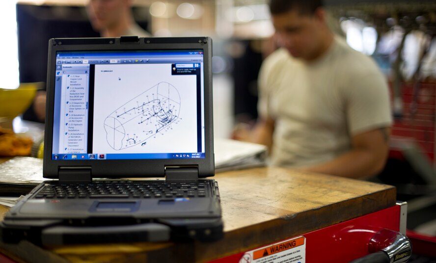 YOKOTA AIR BASE, Japan -- Staff Sgt. Synard Bert, 374th Maintanance Squadron propulsion flight aerospace propulsion journeyman, uses a digital technical order to verify proper installation of hardware on a C-130 engine at Yokota Air Base, Japan on Sept. 11, 2012. Maintainers use technical order maintenance tasks to ensure they are accurately performing the assigned task. (U.S. Photo by Staff Sgt. Stacy Moless)