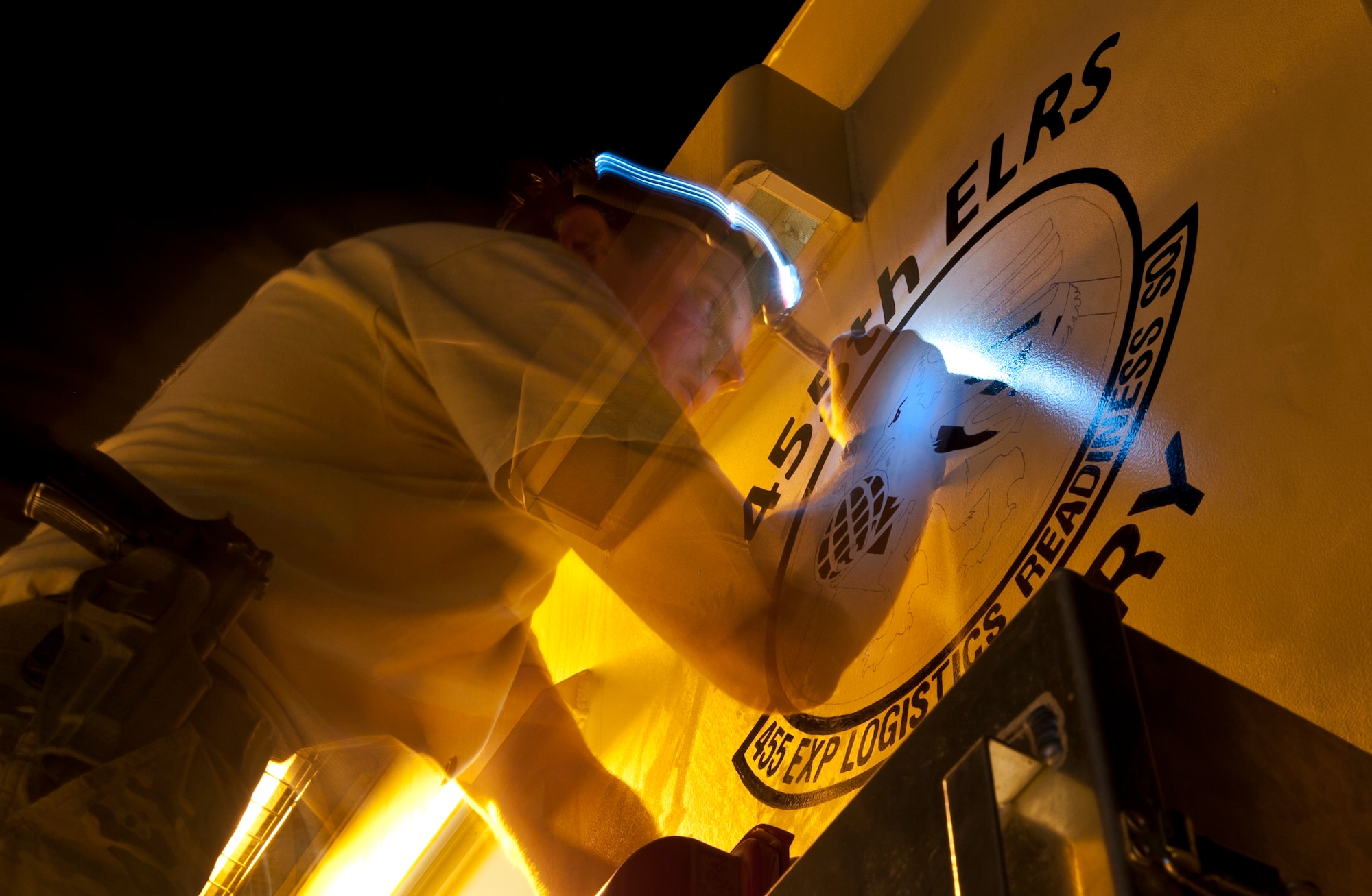 SrA Kenneth Shanks, an Airman assigned to the 455th Air Expeditionary Wing, paints a 455th Expeditionary Logistics Readiness Squadron logo on the new 455 AEW armory at Bagram Airfield, Afghanistan, Sept. 9, 2012. Shanks, a Kingsport Tenn. native, volunteered his time and artistic talent to 455 ELRS in order to put this final detail on the state-of-the-art facility. (U.S. Air Force Photo/Capt. Raymond Geoffroy)