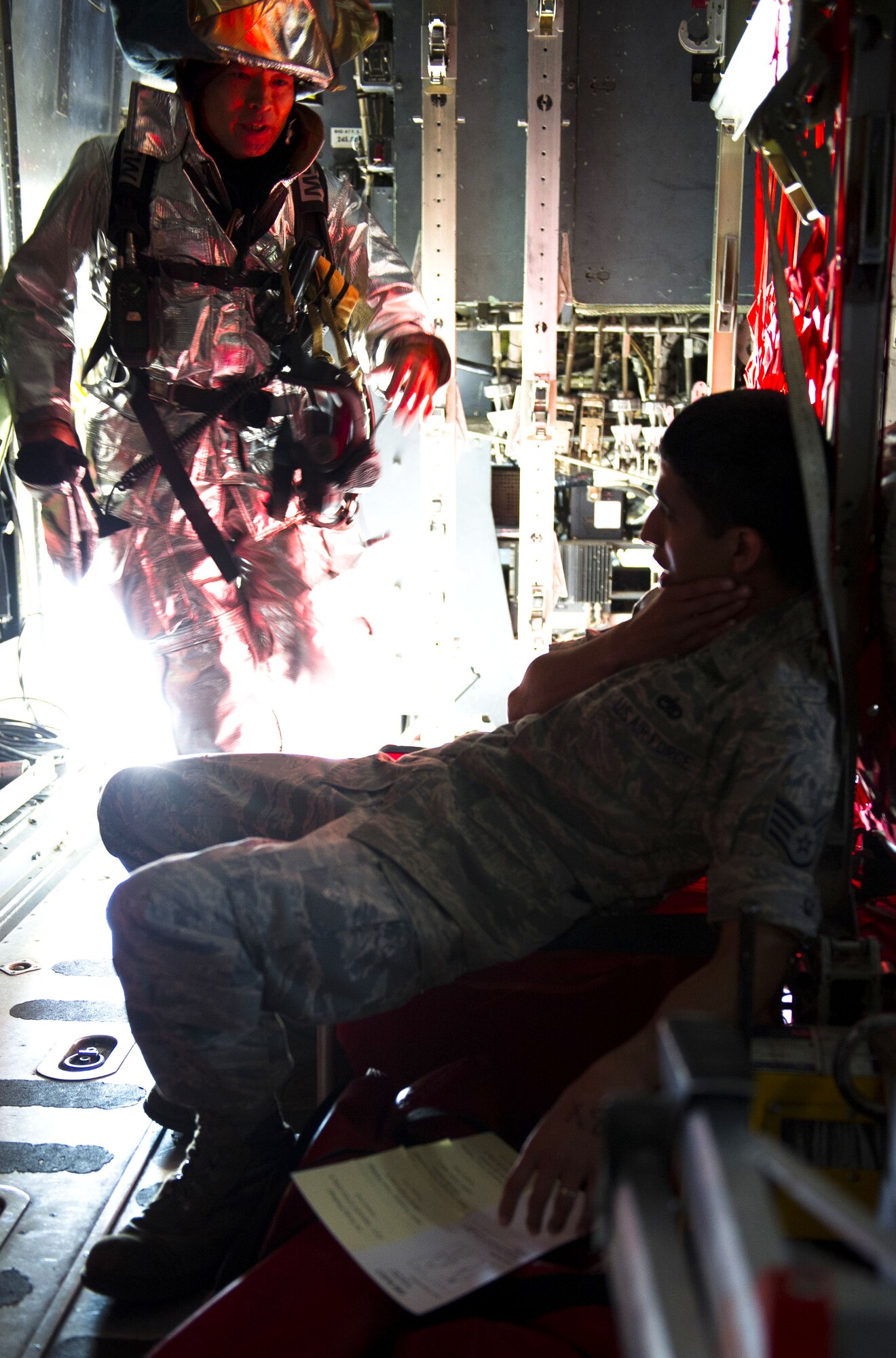 YOKOTA AIR BASE, Japan – Kasuya Kazuyuki, 374th Civil Engineer Squadron firefighter crew chief, assists a simulated victim inside a C-130 Hercules during an emergency management exercise at Yokota Air Base, Japan on Sept. 13, 2012. The scenario gave first responders the opportunity to enhance their emergency management skills. (U.S. Air Force photo by Staff Sgt. Chad C. Strohmeyer)