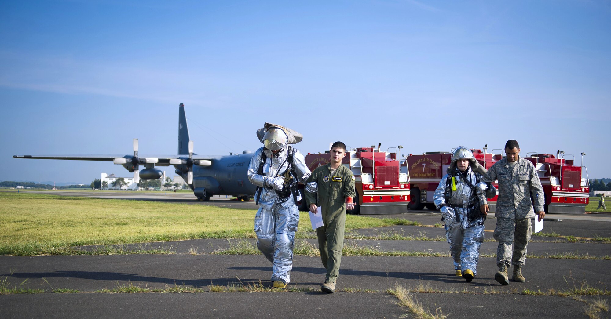 YOKOTA AIR BASE, Japan – 374th Civil Engineer Squadron firefighters escort simulated victims of a C-130 Hercules crash during an emergency management exercise at Yokota Air Base, Japan on Sept. 13, 2012. In addition to having numerous victims, first responders also had to deal with 40 gallons of simulated hydraulic fluid at the crash site. (U.S. Air Force photo by Staff Sgt. Chad C. Strohmeyer)