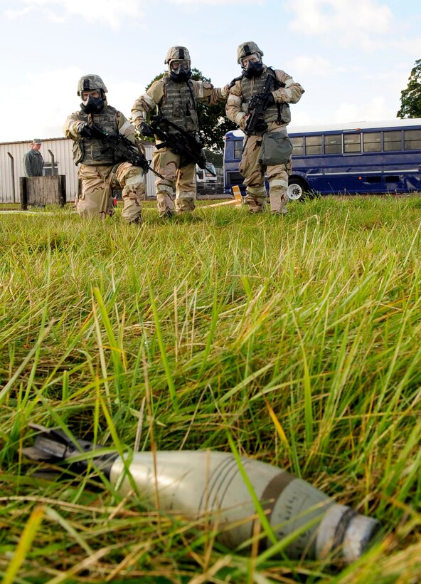 U.S. airmen spot an unexploded ordnance after a simulated chemical attack during an operational readiness exercise on Royal Air Force Base Mildenhall, England, Sept. 11, 2012. The airmen are assinged to the 100th Security Forces Squadron.