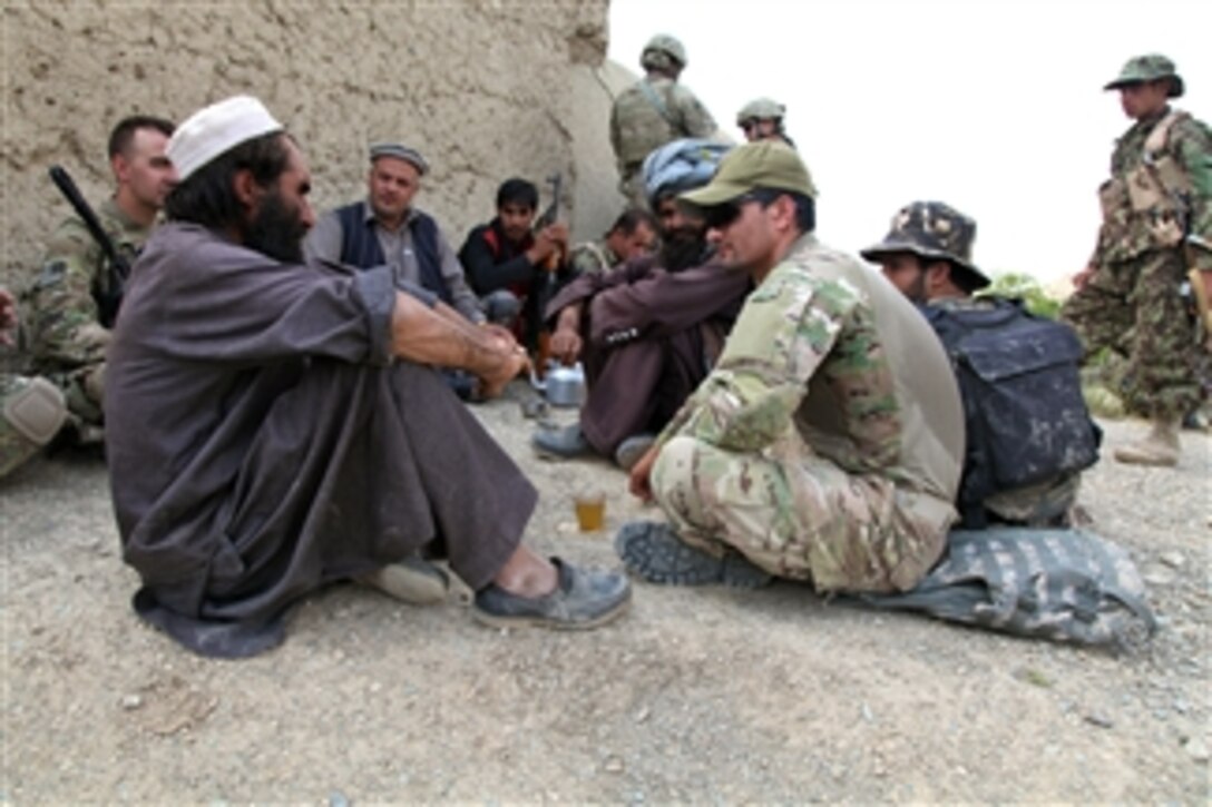 Villagers talk with U.S. soldiers as they have tea outside Forward Operating Base Sharana in the Paktika province of Afghanistan on Aug. 23, 2012.  The soldiers are assigned to Headquarters and Headquarters Troop, 1st Squadron, 4th Cavalry Regiment, 4th Infantry Brigade Combat Team, 1st Infantry Division.  