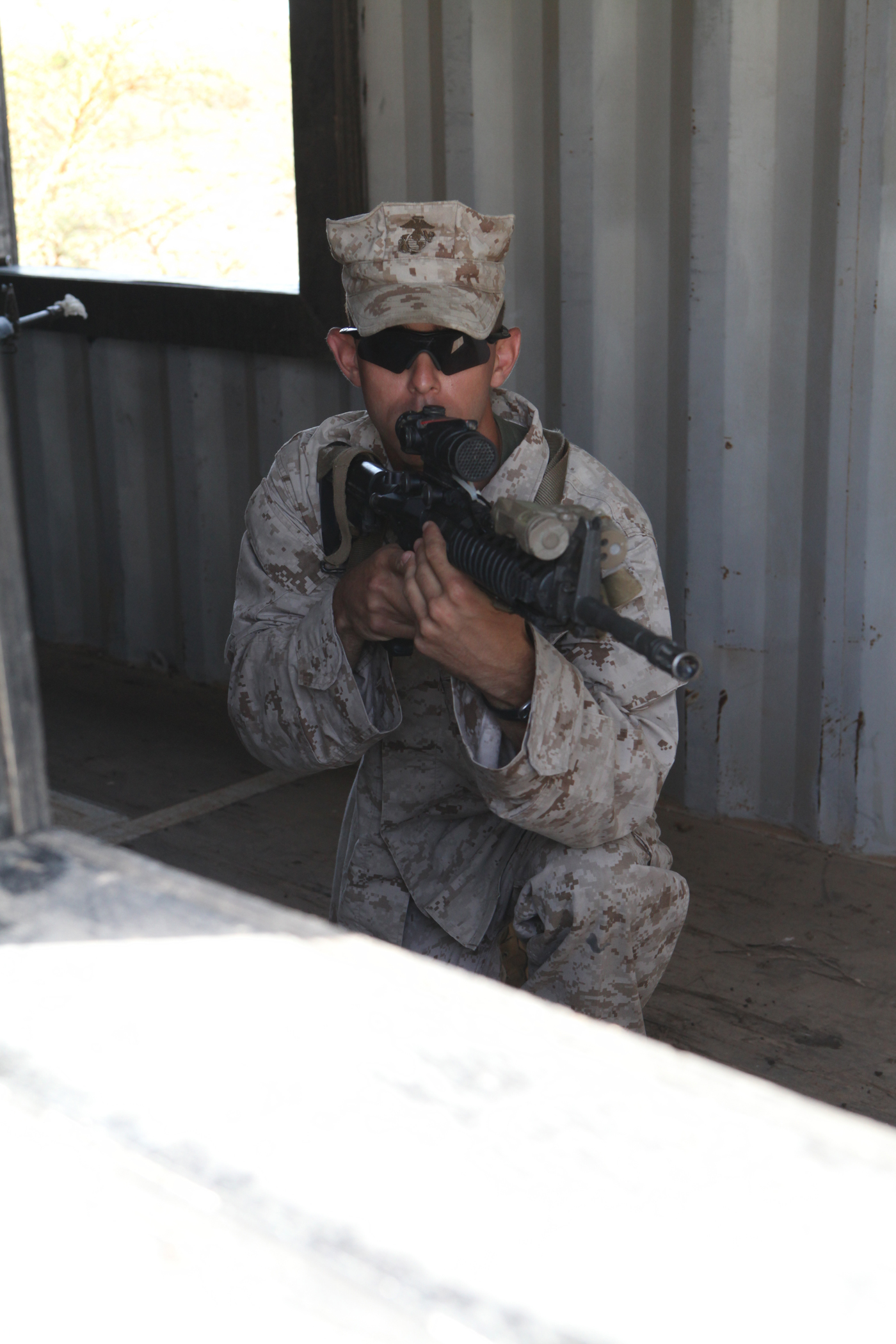 Cpl. Jason Dumke, a team leader with Weapons Company, 3rd Battalion 25th Marine Regiment, posts security in a window during urban combat techniques training, July 13. U.S. service members, primarily Reservists from the Marines, Army, Navy, and Air Force are taking part in Western Accord -- a multi-lateral exercise with Senegalese and several Western African nations. The training exercise runs from June 26 - July 24 and involves Armed Forces of Senegal, Burkina Faso, Guinea, Gambia and France.