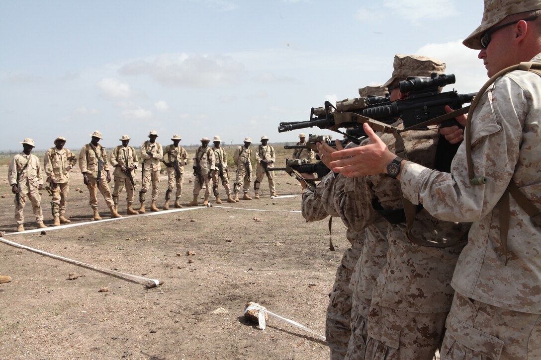 Marines from Weapons Company, 3rd Battalion 25th Marine Regiment, teach members of the Senegalese special forces how to clear a room in a "tape house" during urban combat techniques training, July 13. U.S. service members, primarily Reservists from the Marines, Army, Navy, and Air Force are taking part in Western Accord -- a multi-lateral exercise with Senegalese and several Western African nations. The training exercise runs from June 26 - July 24 and involves Armed Forces of Senegal, Burkina Faso, Guinea, Gambia and France.