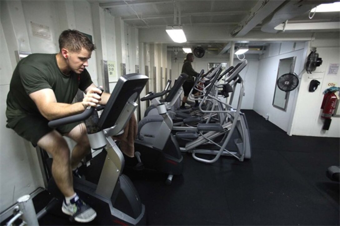 First Lt. Stephen Black (left), operations officer, Headquarters Detachment, and Sgt. Christopher Martinez, motor transport operator, Transportation Support Detachment, both with Combat Logistics Battalion 15, 15th Marine Expeditionary Unit, work out inside one of three fitness rooms aboard the USS Rushmore, Aug. 18. Marines from the MEU exercise regularly during the unit's final training evolution, Certification Exercise. CERTEX differs from previous exercises because Marines and Sailors react to unknown scenarios using the Marine Corps Rapid Response Planning Process.