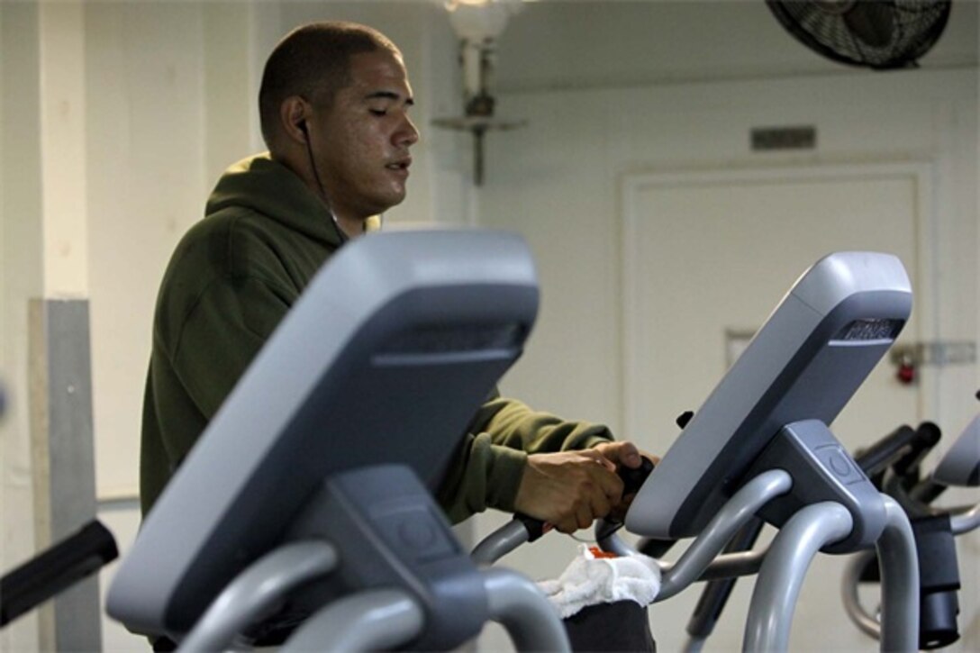 Sergeant Christopher Martinez, motor transport operator, Transportation Support Detachment, Combat Logistics Battalion 15, 15th Marine Expeditionary Unit, exercises on an elliptical machine inside one of three fitness rooms aboard the USS Rushmore, Aug. 18. Marines from the MEU exercise regularly during the unit's final training evolution, Certification Exercise. CERTEX differs from previous exercises because Marines and Sailors react to unknown scenarios using the Marine Corps Rapid Response Planning Process.