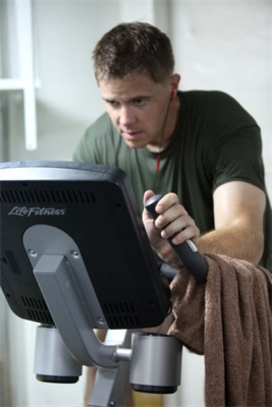 First Lt. Stephen Black, operations officer, Headquarters Detachment, Combat Logistics Battalion 15, 15th Marine Expeditionary Unit, works out on a stationary bike inside one of three fitness rooms aboard the USS Rushmore, Aug. 18. Marines from the MEU exercise regularly during the unit's final training evolution, Certification Exercise. CERTEX differs from previous exercises because Marines and Sailors react to unknown scenarios using the Marine Corps' Rapid Response Planning Process.