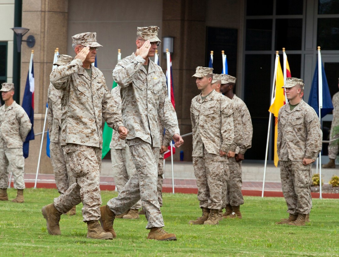 Brig. Gen. James S. Hartsell and Maj. Gen. James M. Lariviere march the formation line during the 4th Marine Division change of command ceremony at the Marine Corps Support Facility New Orleans, Sept. 8. During the march, the generals inspected and reviewed their troops that stood in formation. Lariviere will serve at the Pentagon after two and a half years of leading 4th MarDiv.