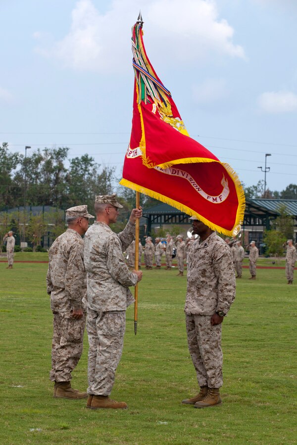 Maj. Gen. James M. Lariviere prepares to pass on the Marine Corps colors to Brig. Gen. James S. Hartsell during the 4th Marine Division change of command ceremony at the Marine Corps Support Facility New Orleans, Sept. 8. The passing of the colors is a symbol of exchanging command responsibility and leadership. Lariviere will serve at the Pentagon after two and a half years of leading 4th MarDiv.