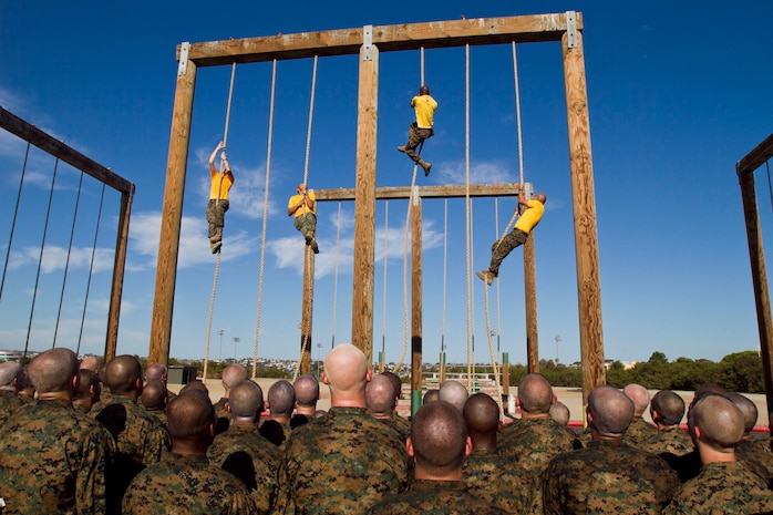 Recruits of Company F, 2nd Recruit Training Battlion, watch as drill instructors demonstrate how to properly climb the rope during the obstacle course aboard Marine Corps Recruit Depot San Diego Sept. 7. Recruits were instructed to use one of either two methods to climb the rope, the "j-hook" or the "s-method."