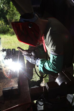 Lance Cpl. Jacob D. Waters, a welder with Combat Logistics Regiment 25, 2nd Marine Logistics Group, repairs a piece of equipment during a training exercise aboard Camp Lejeune, N.C., Sept. 11, 2012.  Maintenance Marines with CLR-25 set up an Intermediate Maintenance Activity facility, which is a huge garage that provides the tools needed to repair almost any piece of gear Marines use.